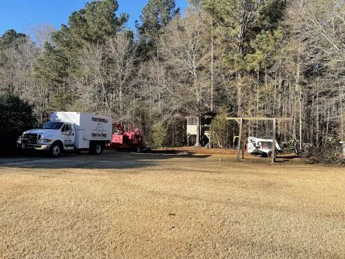 My experience with Porterfield was excellent! They removed 3 pines from our back yard that were surrounded by ornamental