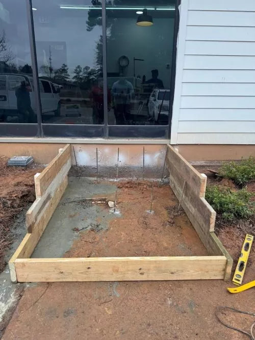Hearn Landscaping installed a paver patio, fire pit, and seating wall on the backside of our home, along with LV lighting